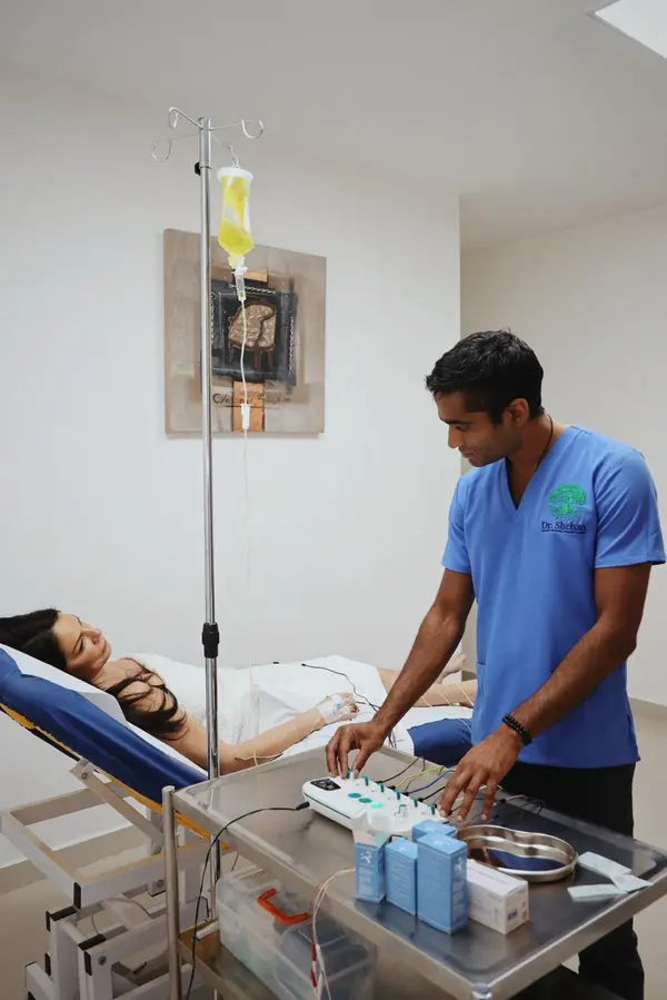 Dr Shehan delivering integrated electroacupuncture and IV treatment