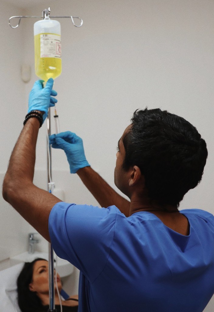 Dr Shehan preparing an IV drip in clinic